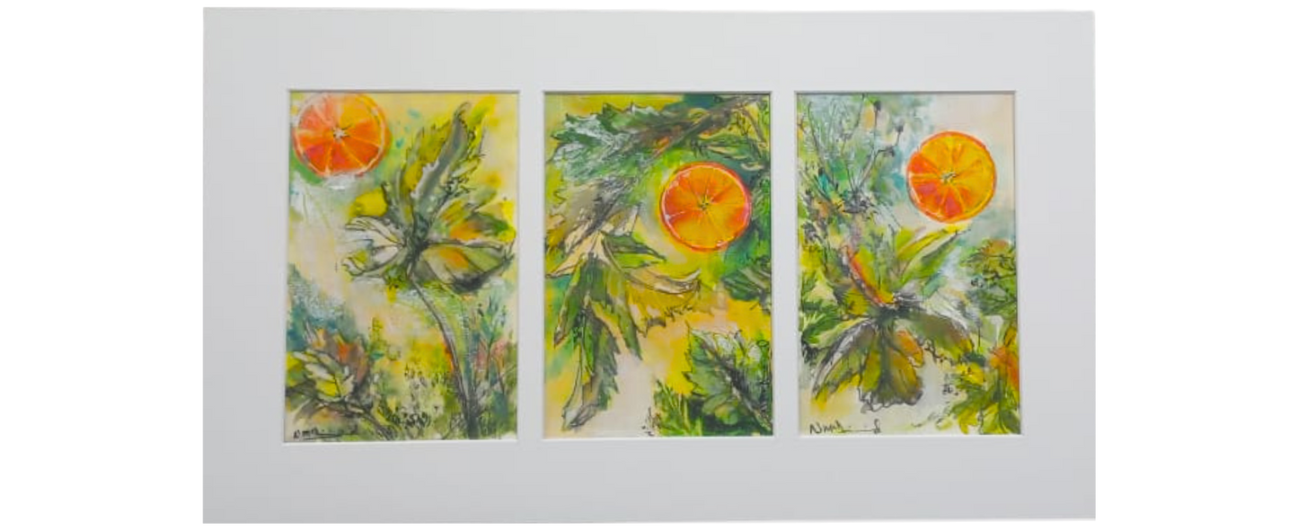 Framed triptych of three watercolour paintings showing orange slices floating among green leaves, set against a soft yellow background.