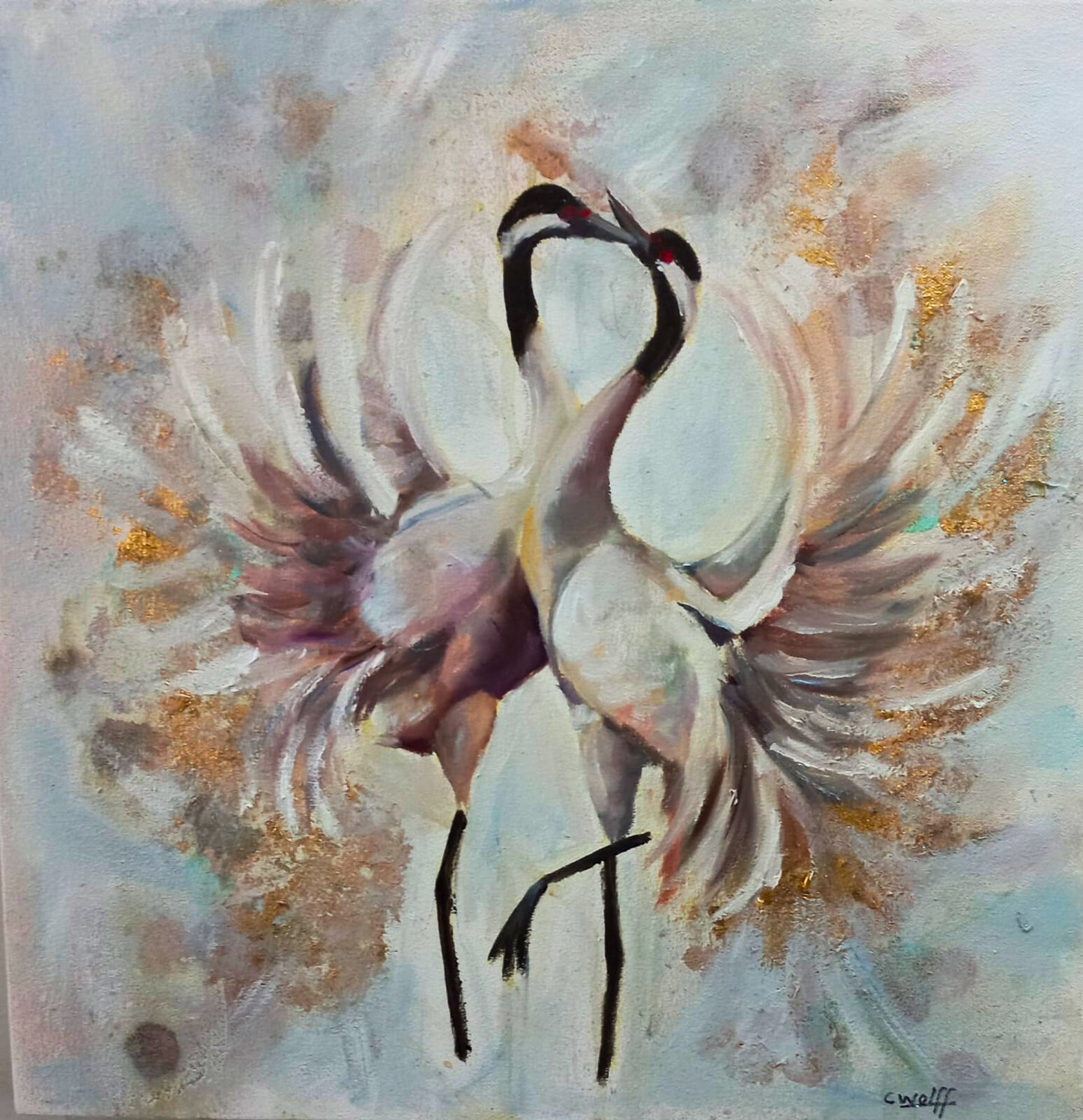 Oil painting of two cranes standing close together, wings fanned outward, against a soft abstract background with gold accents.
