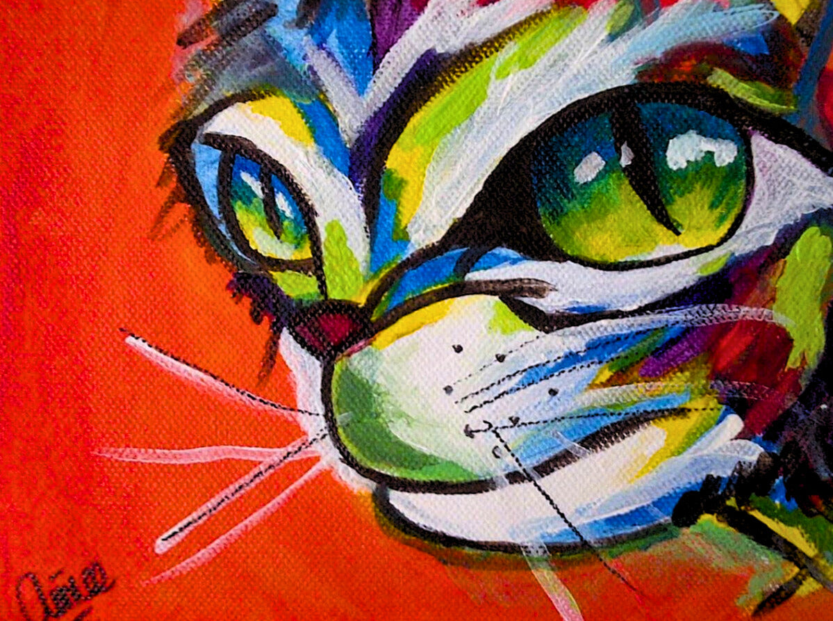 Colourful abstract cat face painting by Aimee Grautier with dramatic green eyes and vivid rainbow fur on a fiery red canvas — eye-catching animal art for bold home decoration.