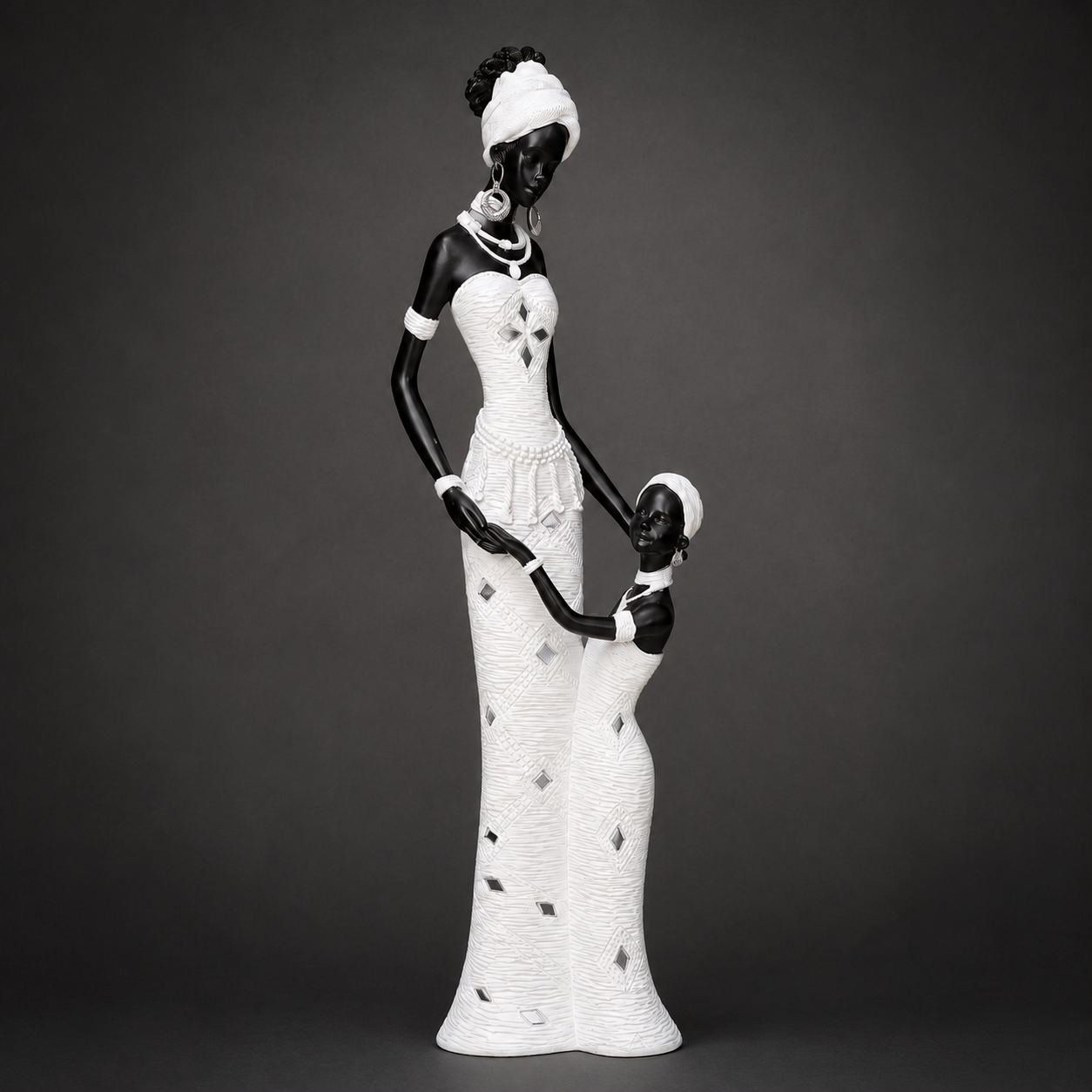 Black and White African Mother and Child Sculpture photographed on a warm beige studio background
