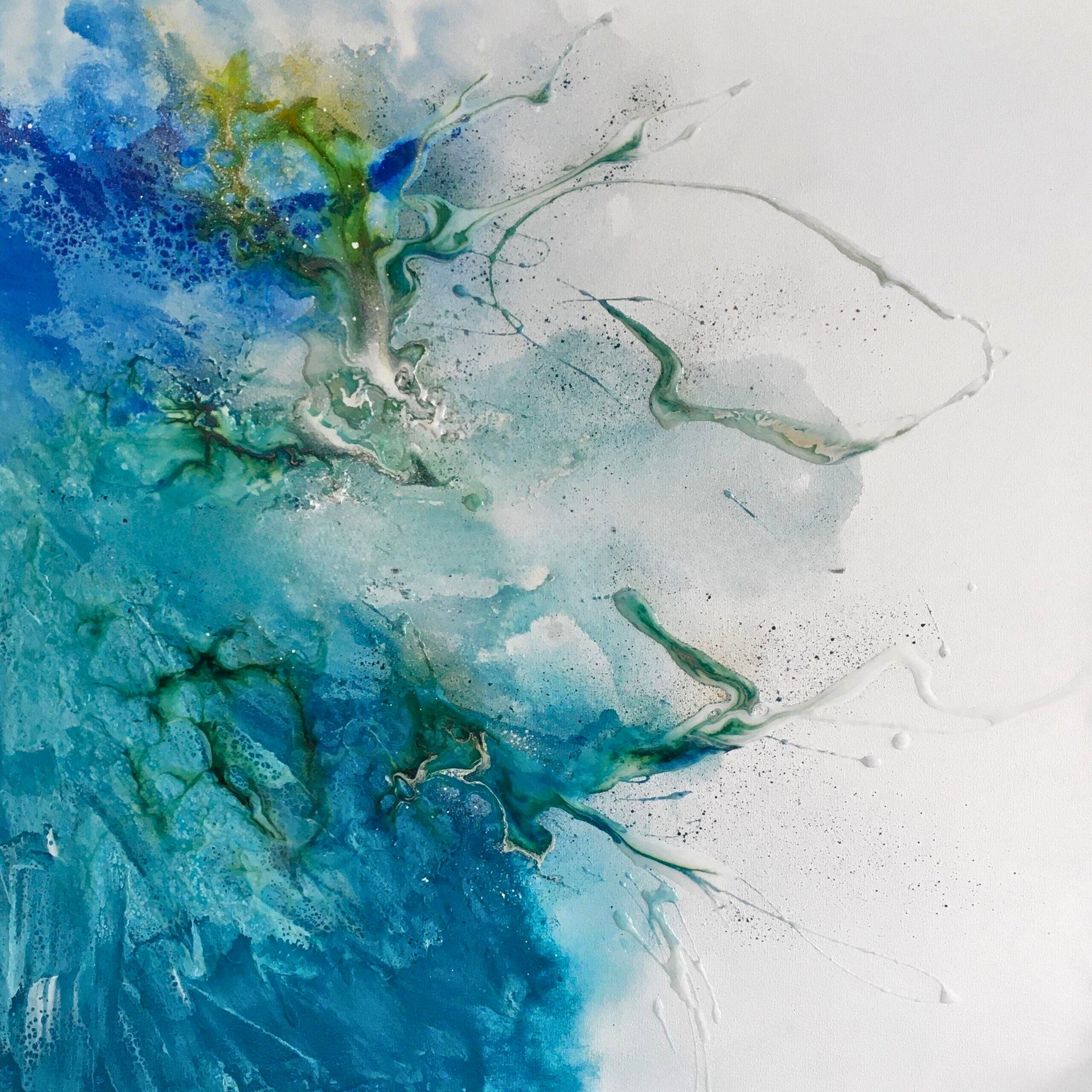Mixed media abstract with splashes of blue, green, and white paint radiating from a central burst, accented with black speckles and fine lines.