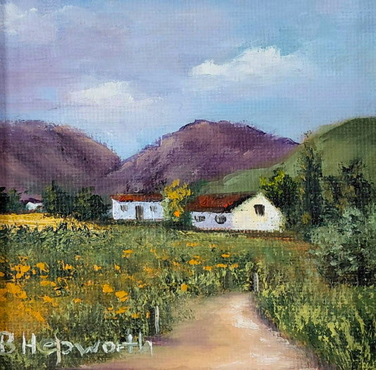 Oil painting of a dirt path through yellow wildflowers leading to white cottages under rolling hills.