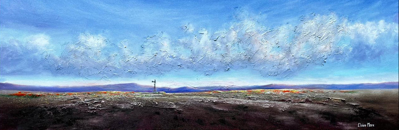 Mixed media landscape with a lone windmill standing across an open field, distant mountains, and a soft cloudy sky.