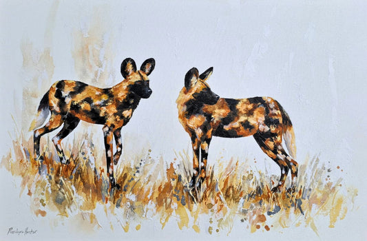 Mixed media painting of two African wild dogs standing in tall golden grass, their distinctive spotted coats and alert ears rendered with expressive brushwork.