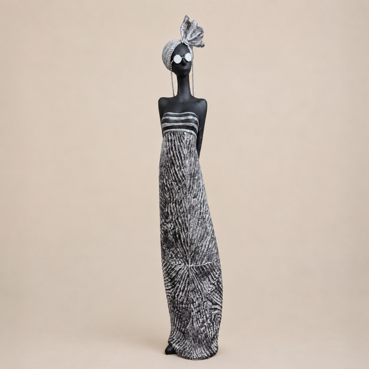Black and Silver Standing Lady Sculpture photographed on a warm beige studio background