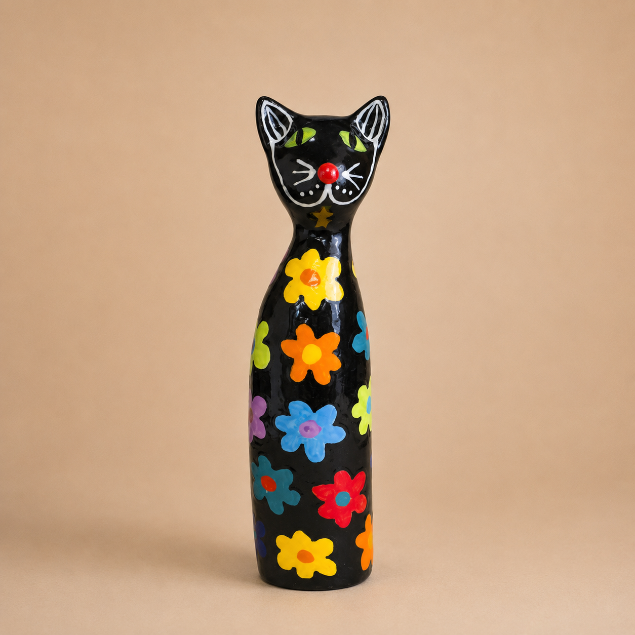 Handcrafted Black Floral Ceramic Cat Figurine photographed on a warm beige studio background