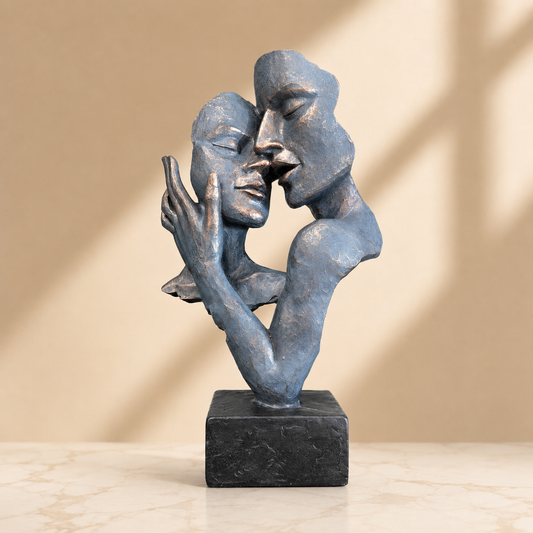 Blue Abstract Kissing Couple Sculpture photographed on a warm beige studio background