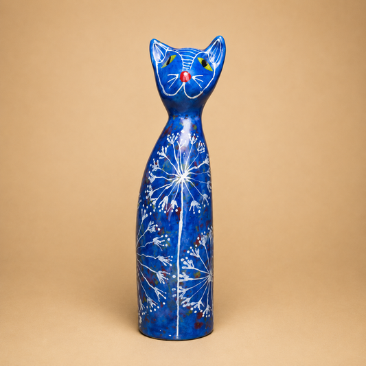 Blue Floral Cat Figurine photographed on a warm beige studio background