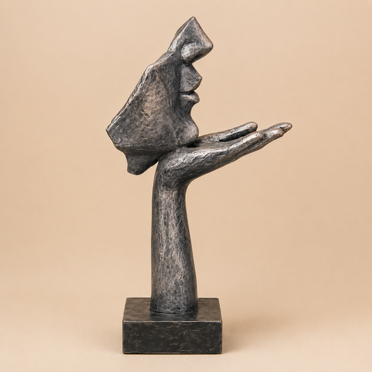 Contemplative Face in Hand Sculpture photographed on a warm beige studio background