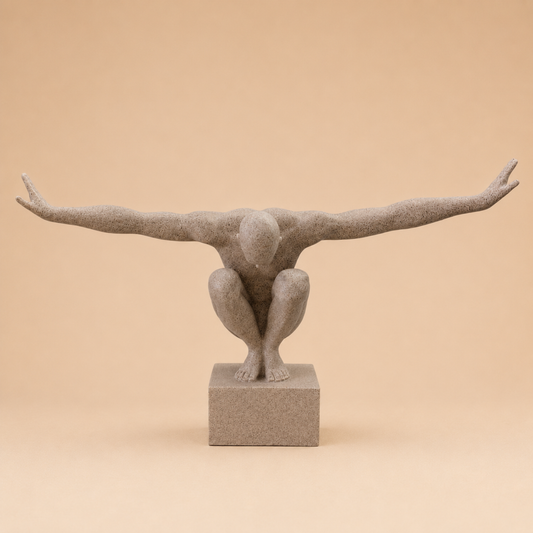 Crouching Balance Figure Sculpture photographed on a warm beige studio background