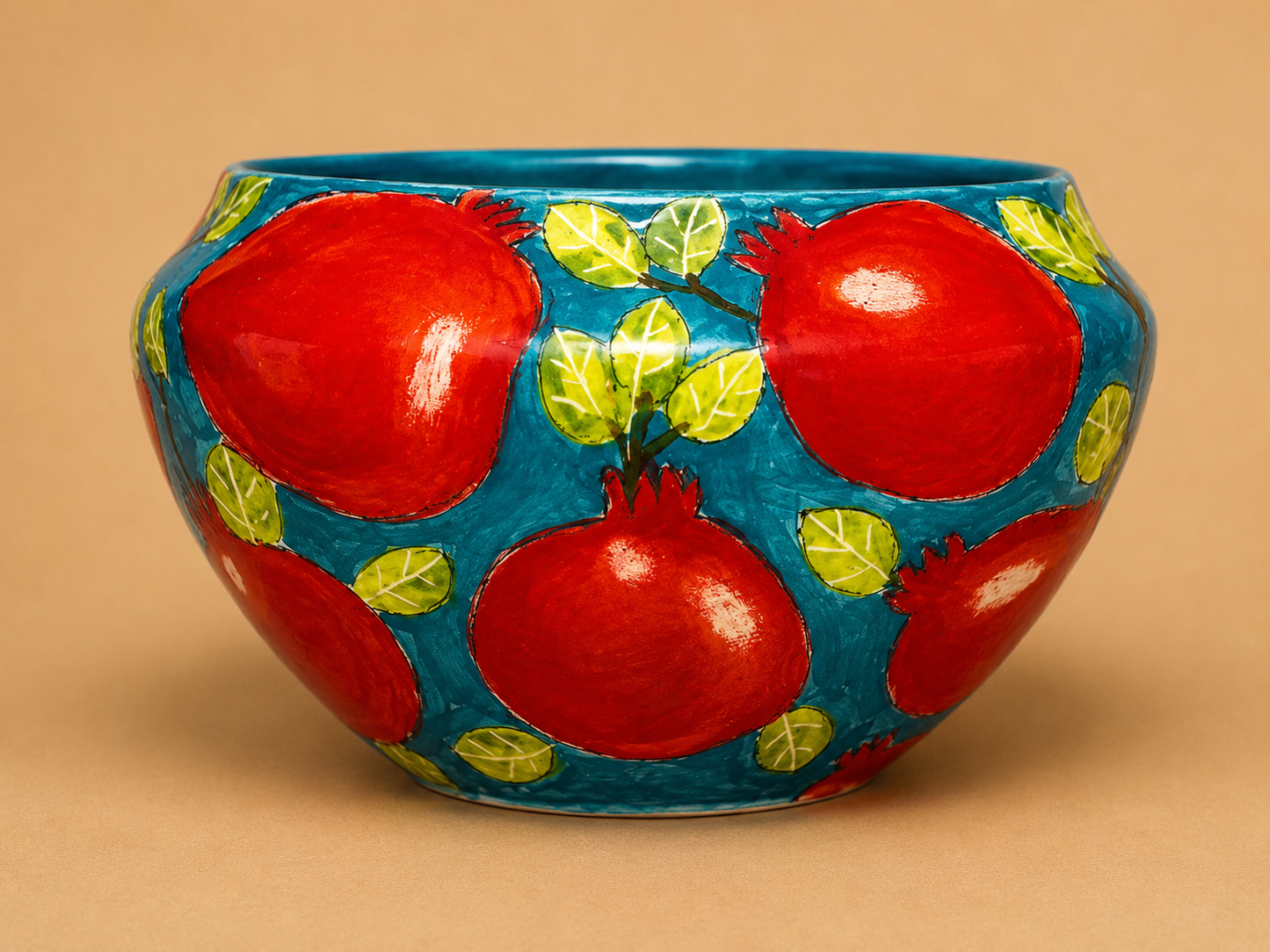 Handcrafted Pomegranate Round Ceramic Bowl photographed on a warm beige studio background