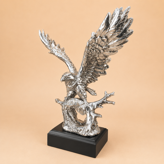 Silver Eagle on Branch Statue photographed on a warm beige studio background