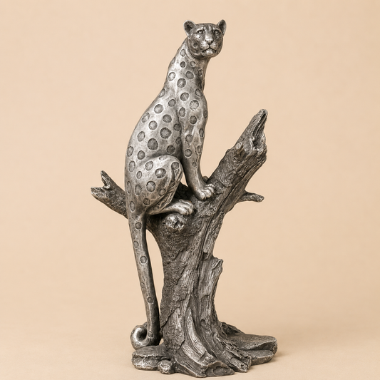 Silver Leopard on Tree Statue photographed on a warm beige studio background