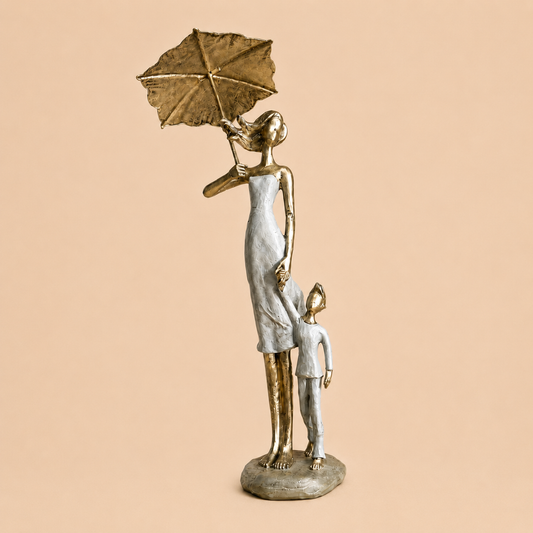 Silver Mother and Child Umbrella Sculpture photographed on a warm beige studio background