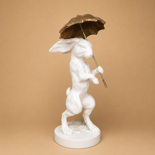 White Rabbit with Umbrella Figurine photographed on a warm beige studio background